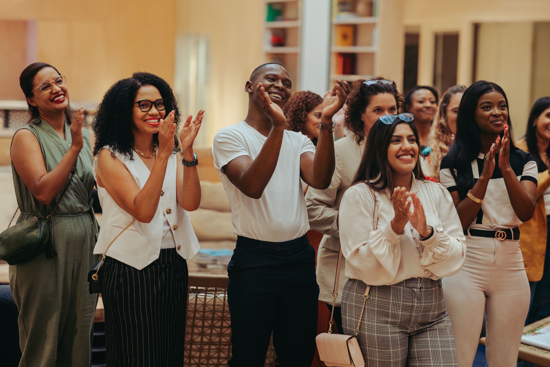 Happy employees applauding in office